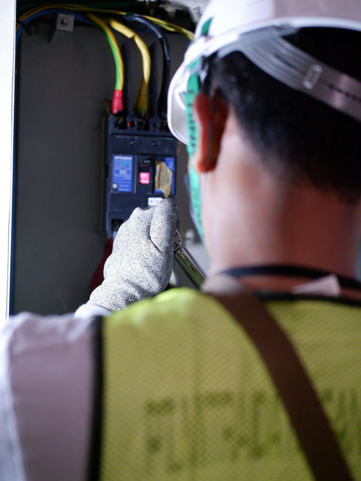 Electrician testing a breaker box, where well pump control box faults often start