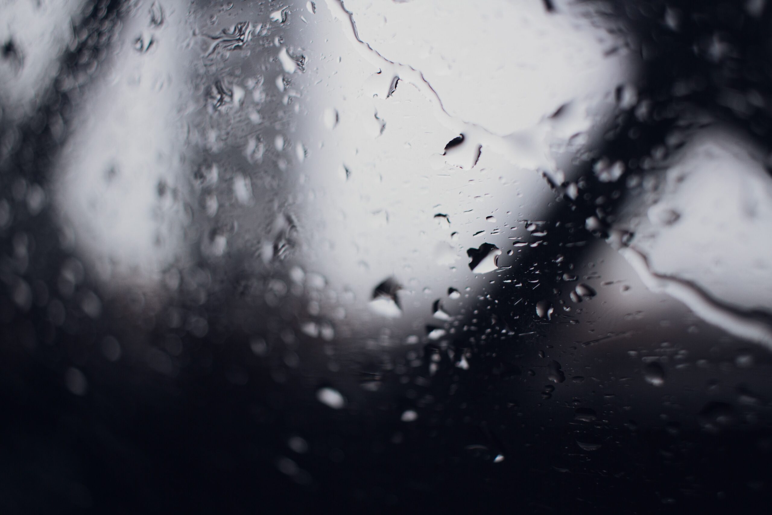 Heavy rain on a window during a storm that can flood a private well