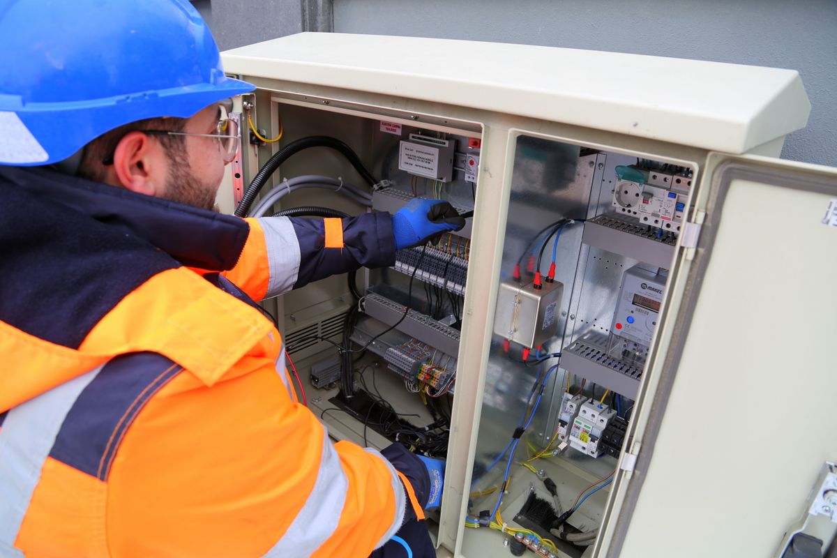 Electrician checking an outdoor electrical panel when a well pump is not working after a power outage