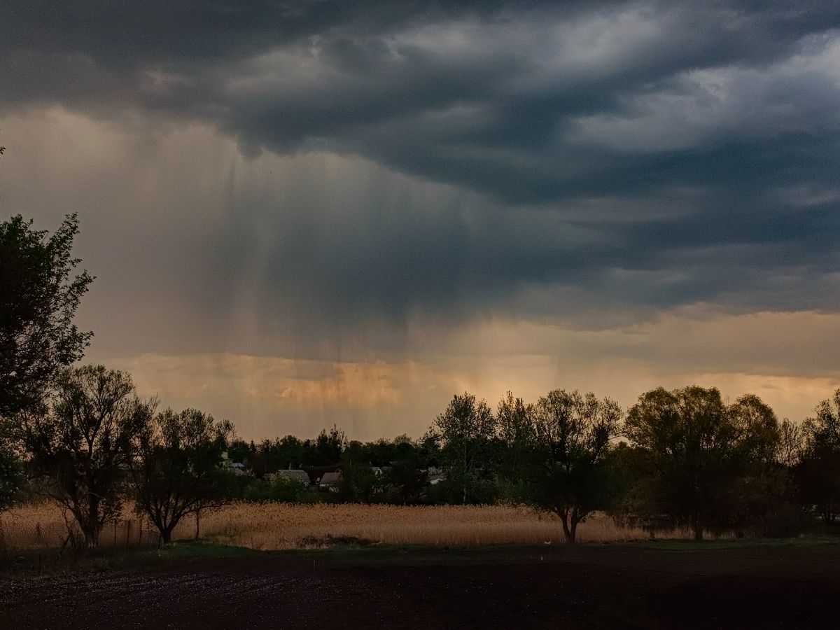 Dark storm clouds over a rural field before heavy rain, when a sump pump not working becomes a problem